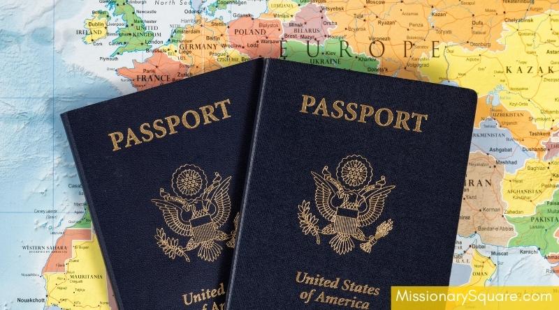 A colorful map lies on a table with two passports on top of it. text overlay says missionary square dot com